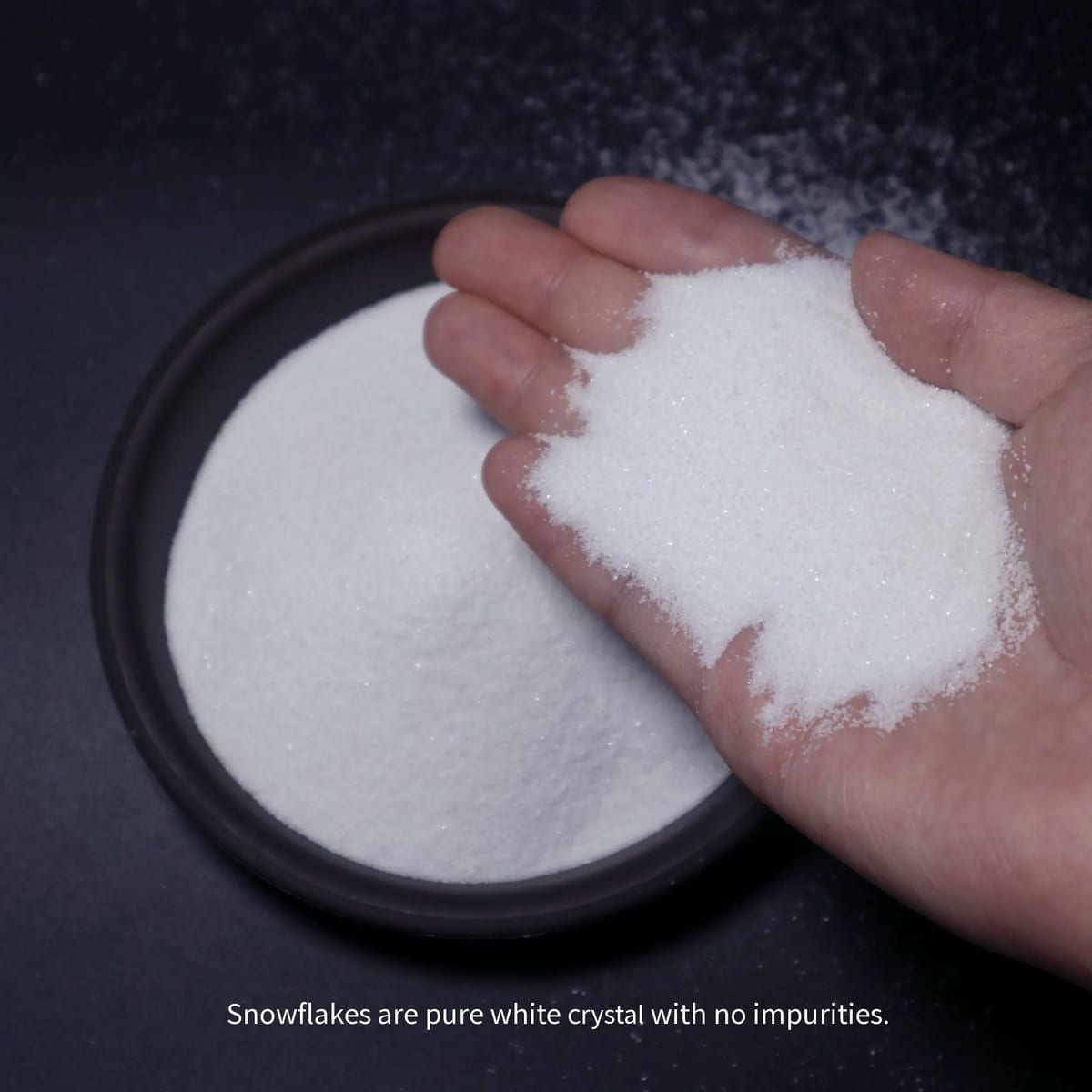 Fine decorative sand held in hand to show texture